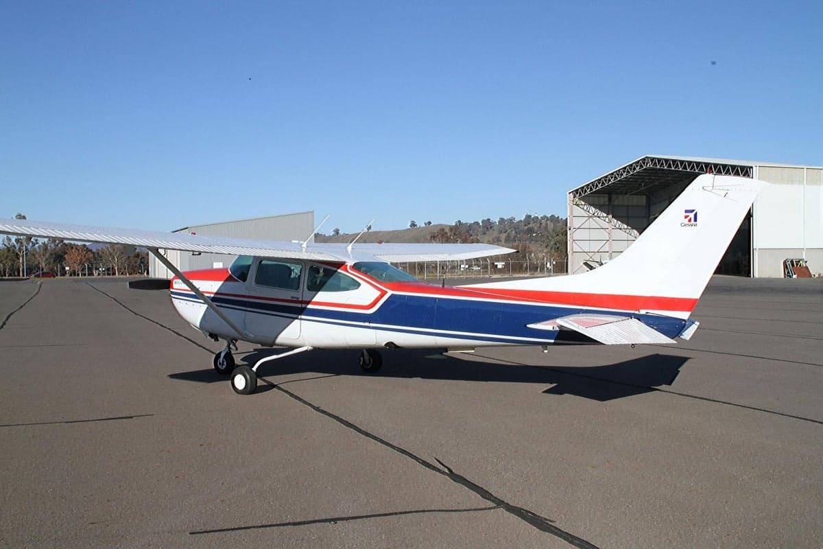 Side view of the aircraft on the tarmac with a red, white, and blue paint scheme.