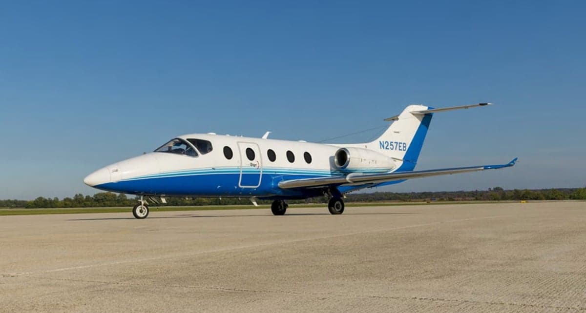 Hawker jet with blue and white paint scheme on the tarmac.