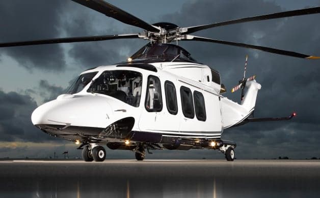 A white and black helicopter on a reflective surface.