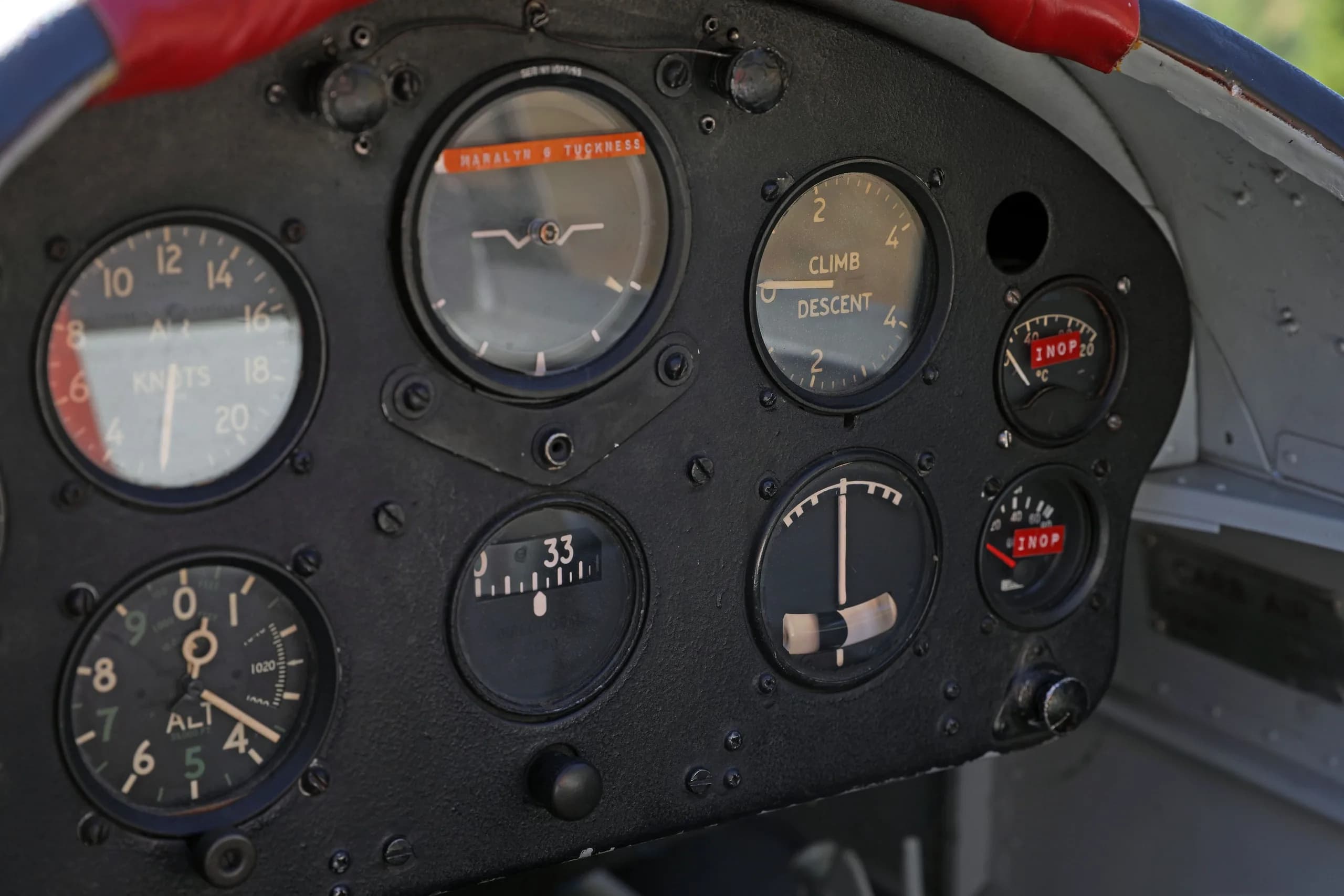 A close-up, angled view of the right side of a vintage aircraft instrument panel with several round gauges.