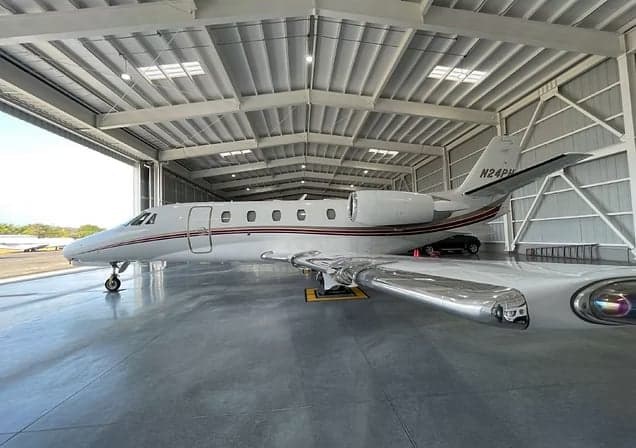 Citation CJ3 aircraft with registration N876BB inside a hangar.