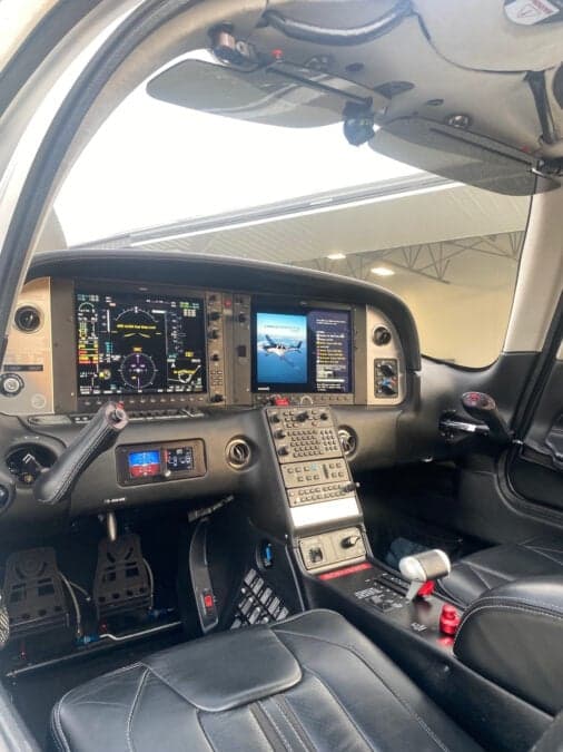 The cockpit of a Cirrus aircraft features a modern avionics suite and comfortable seating.