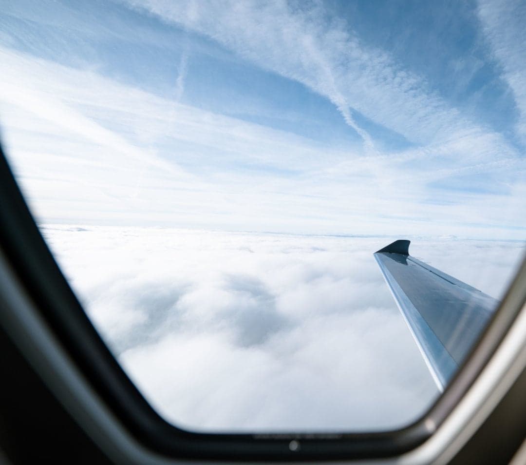 View of the wing and sky from inside the aircraft cabin.