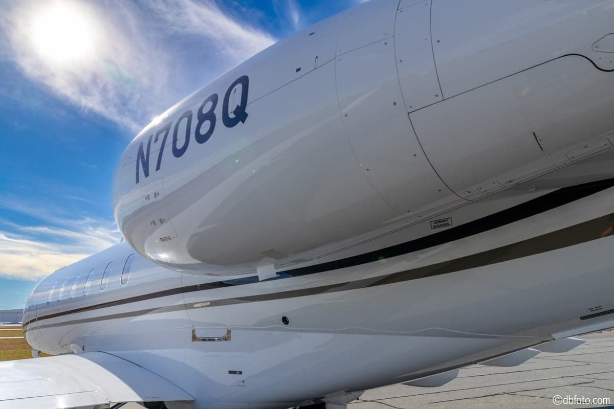 A close-up view of the engine nacelle of the Bombardier Challenger N708Q, showing the registration number.