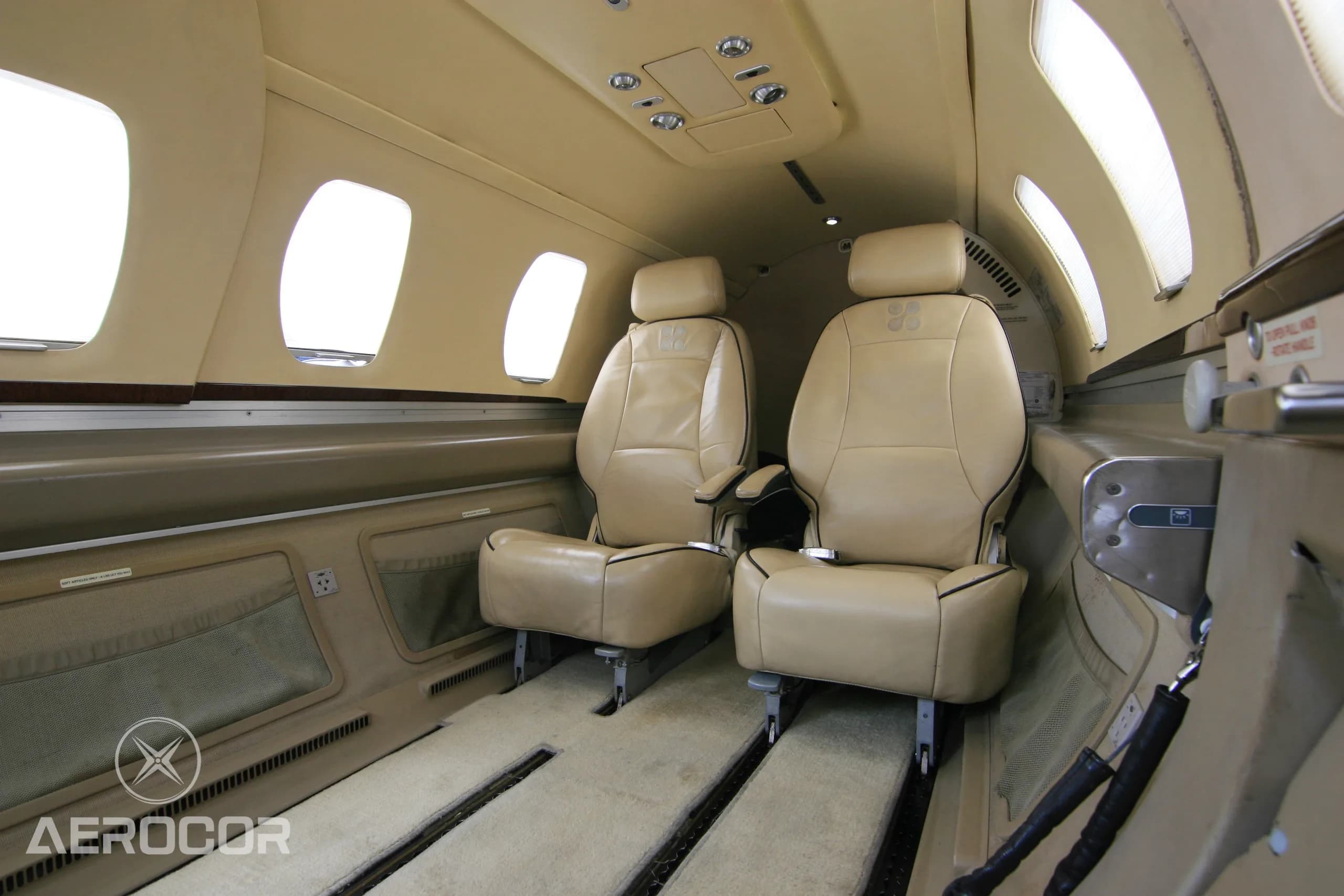 Two tan leather passenger seats in the cabin of an Eclipse 500 jet.