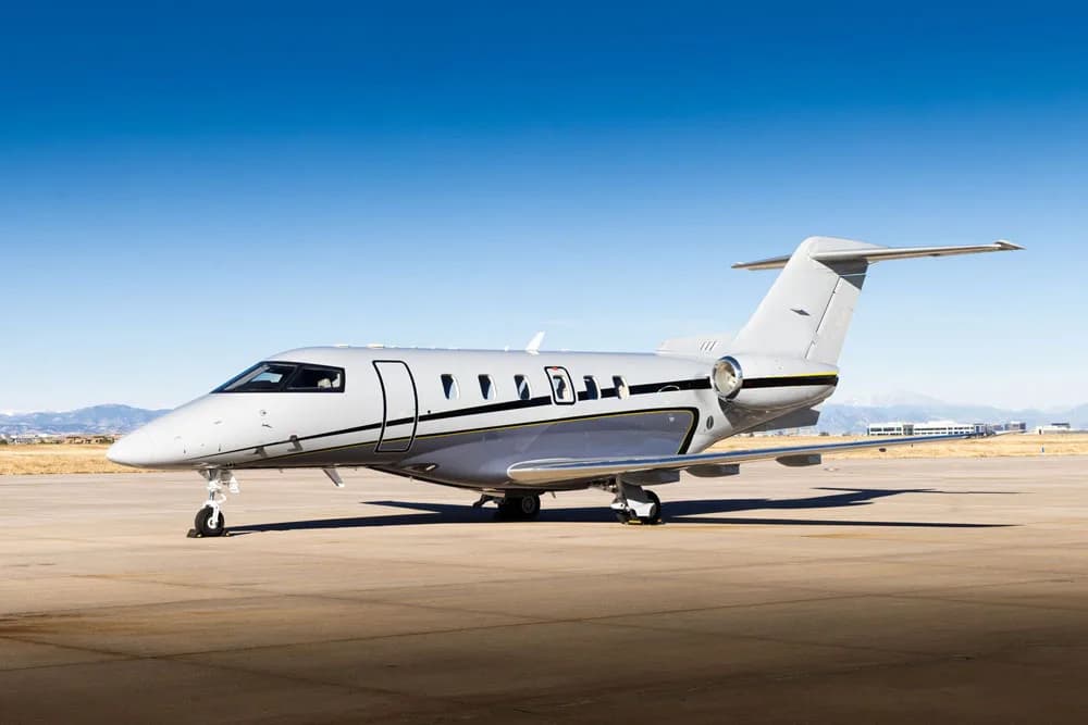 Side view of a light gray jet on the tarmac.