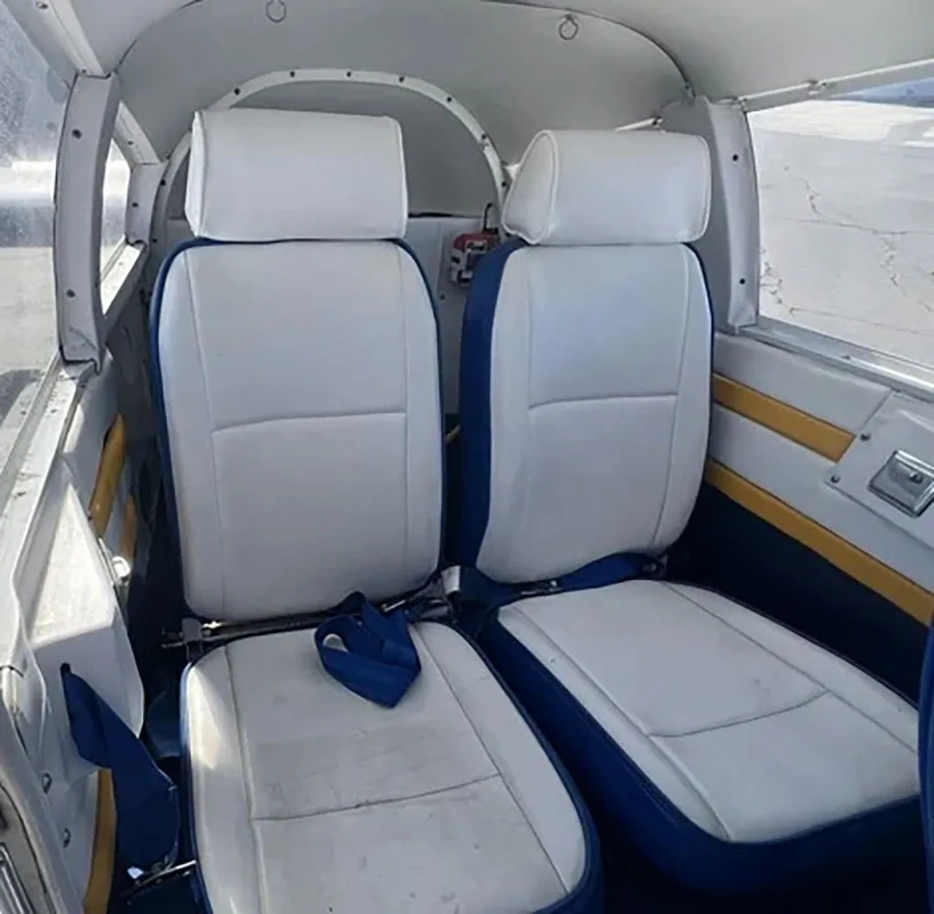 Two white and blue upholstered rear cabin seats inside the aircraft.