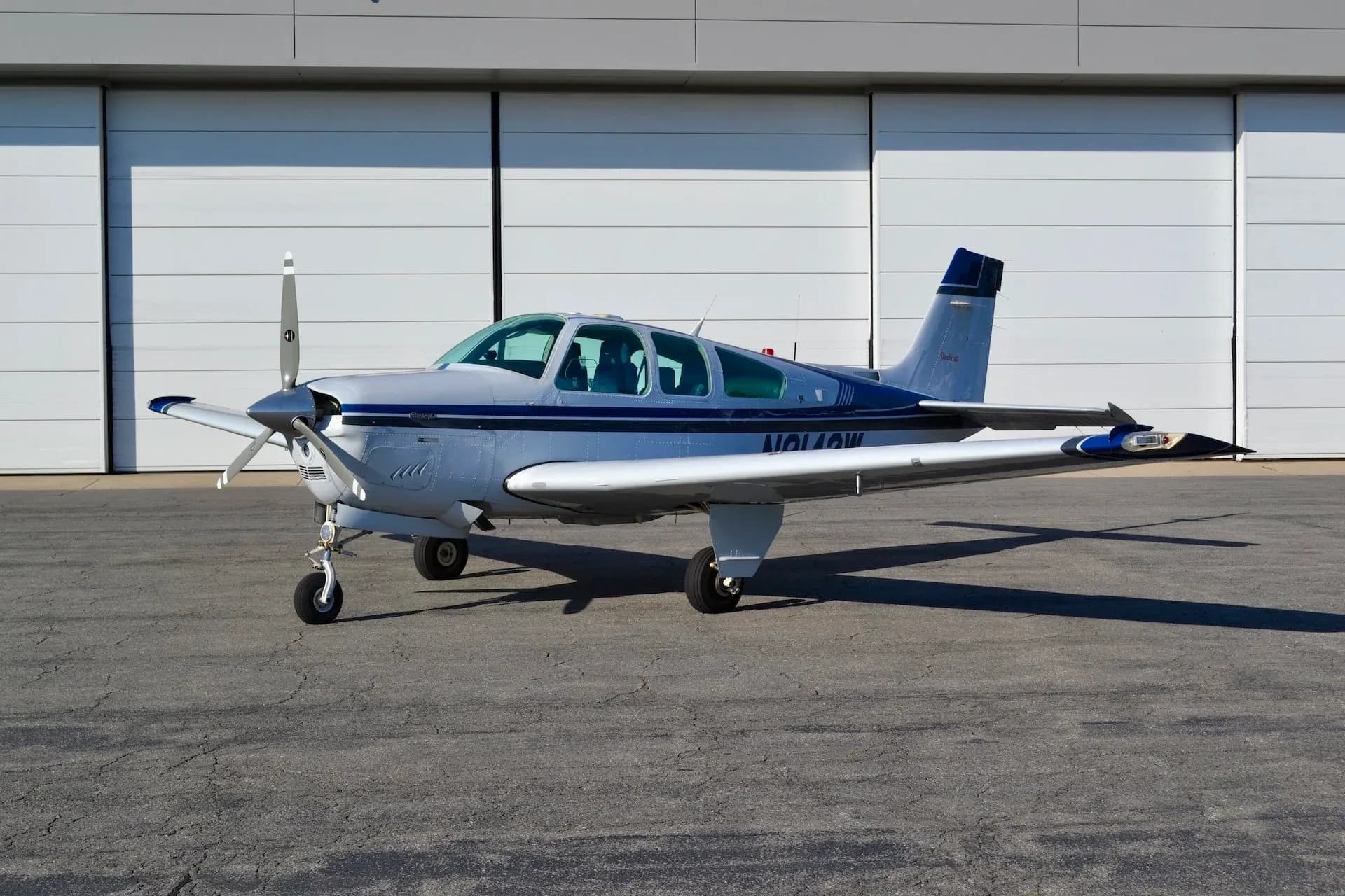 Side view of the Beechcraft Bonanza N8142W parked on the tarmac.