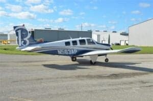 N563AP Bonanza aircraft parked on the tarmac, side view.