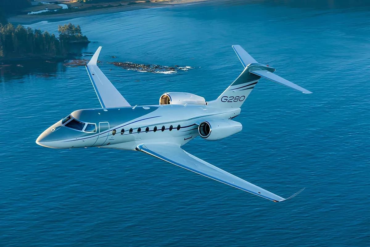 A Gulfstream G280 flying over the ocean.