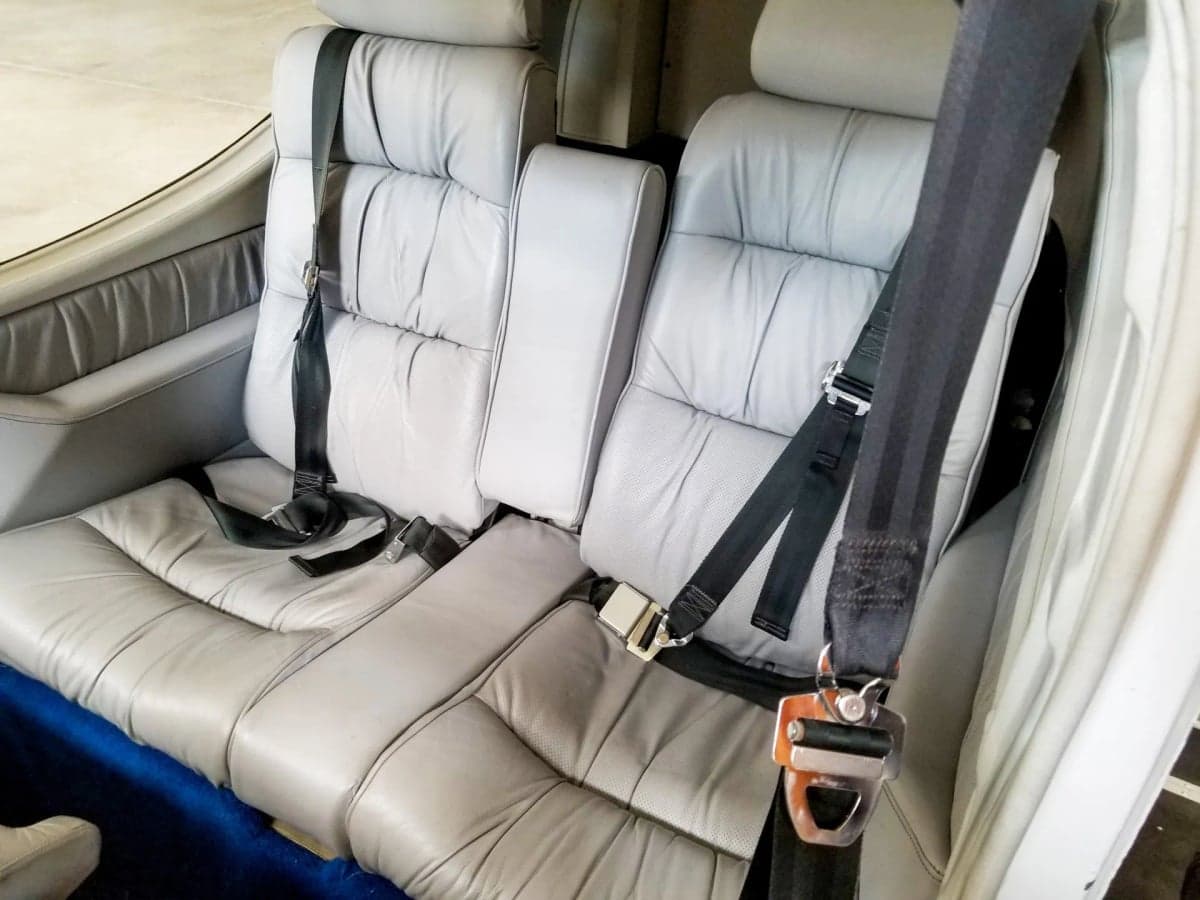 Aircraft interior with gray leather seats.