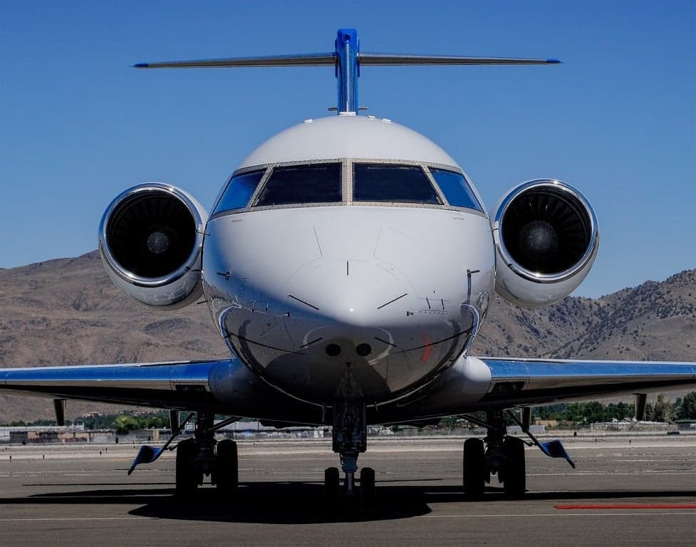 Front view of a Bombardier Challenger jet on the tarmac.