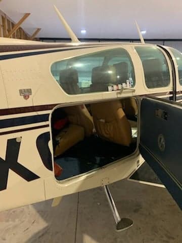 View of the aircraft interior through an open baggage door.
