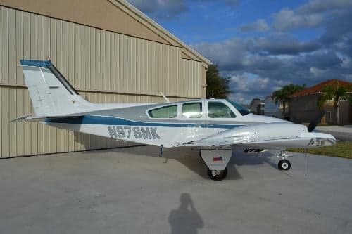 Side view of a Beechcraft Bonanza with registration N976MK.