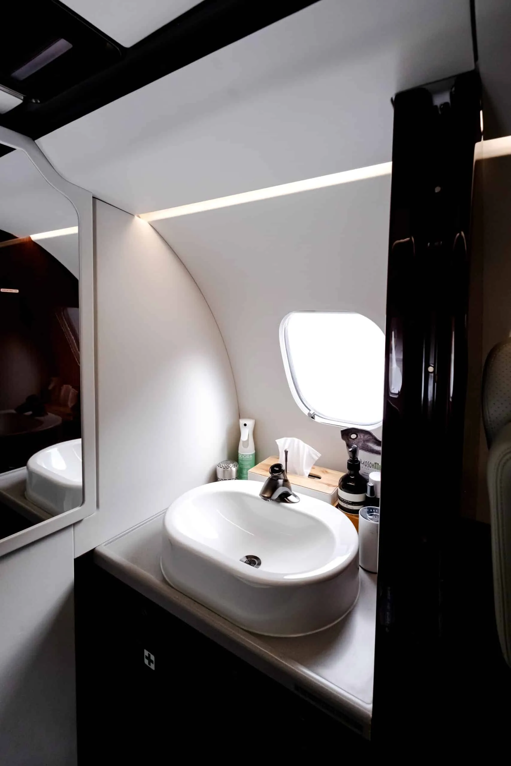 View of the aircraft lavatory with sink and mirror.