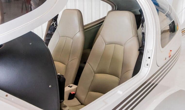 Interior view of the Diamond DA40's cabin showing the seats and gull-wing door.