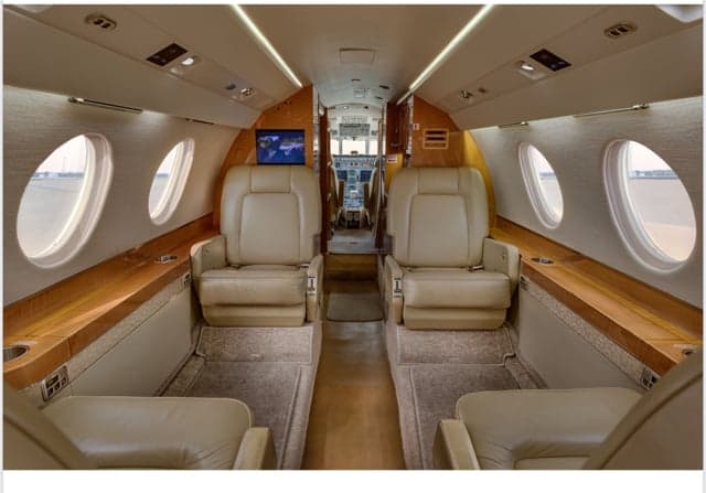 The interior of the Falcon jet, showing the seating arrangement and forward view.