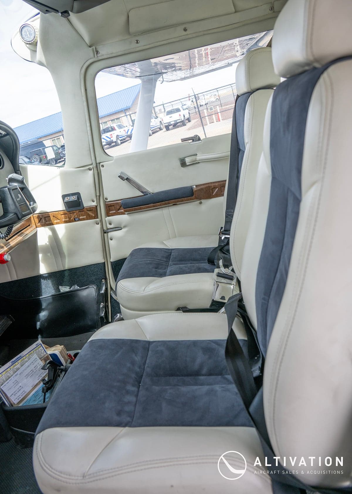 The cockpit of a Cessna aircraft, showcasing the instrument panel and control yokes.