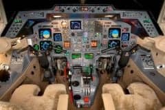 The cockpit of an aircraft with many instruments and controls.