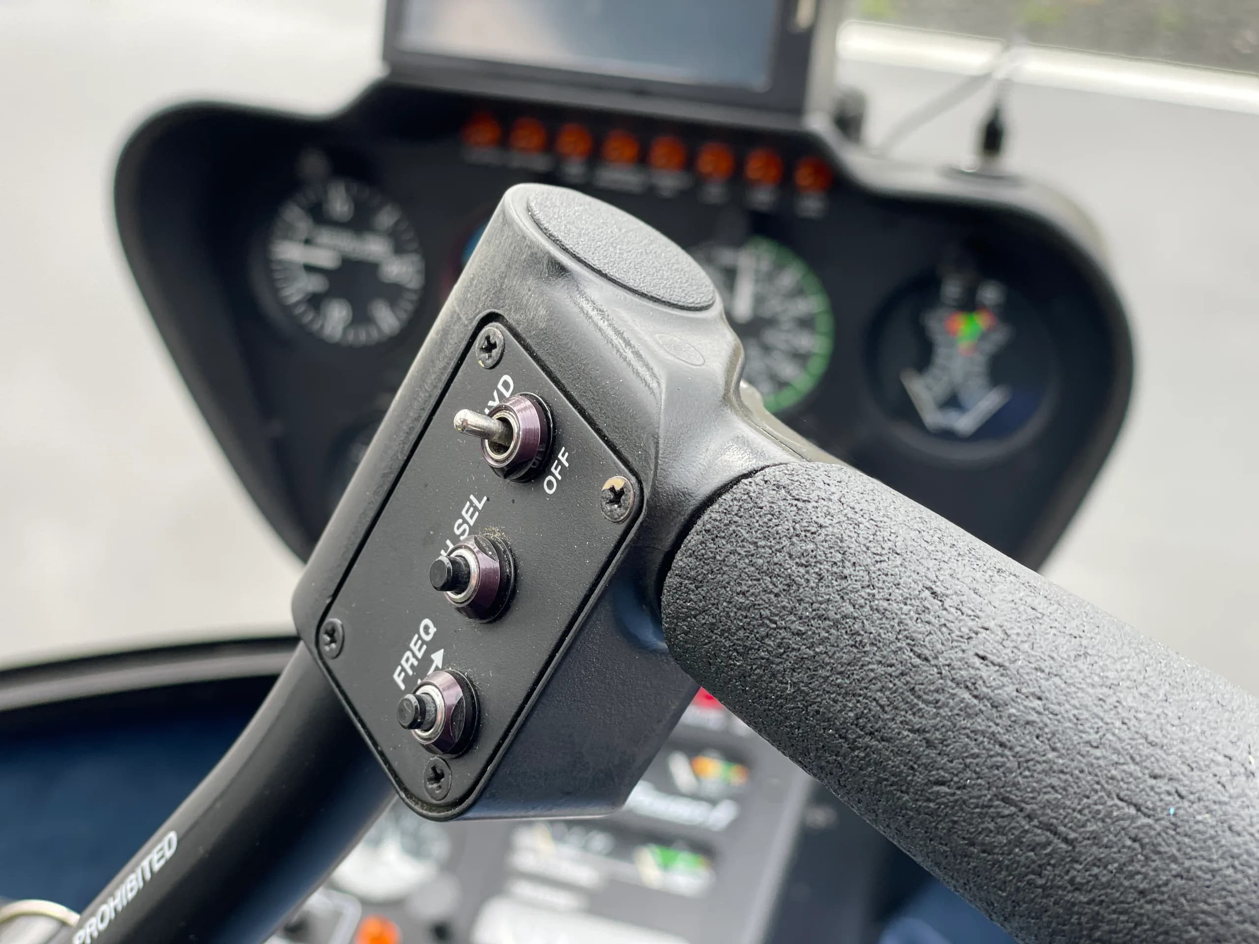 Close up of the cyclic and instrument panel of the Robinson R44 Raven I OE-XXQ helicopter.