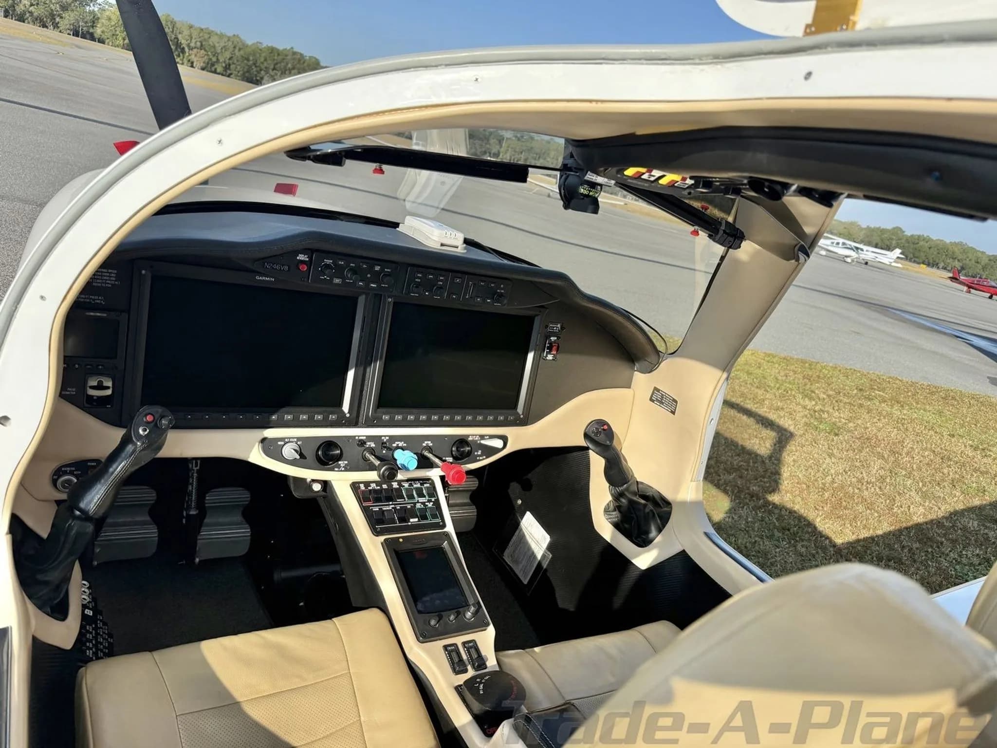 A view from inside the Cessna TTx cockpit, showing the instrument panel and a runway outside.
