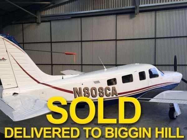 A Piper aircraft with registration N808CA in a hangar, marked with 'SOLD' text.