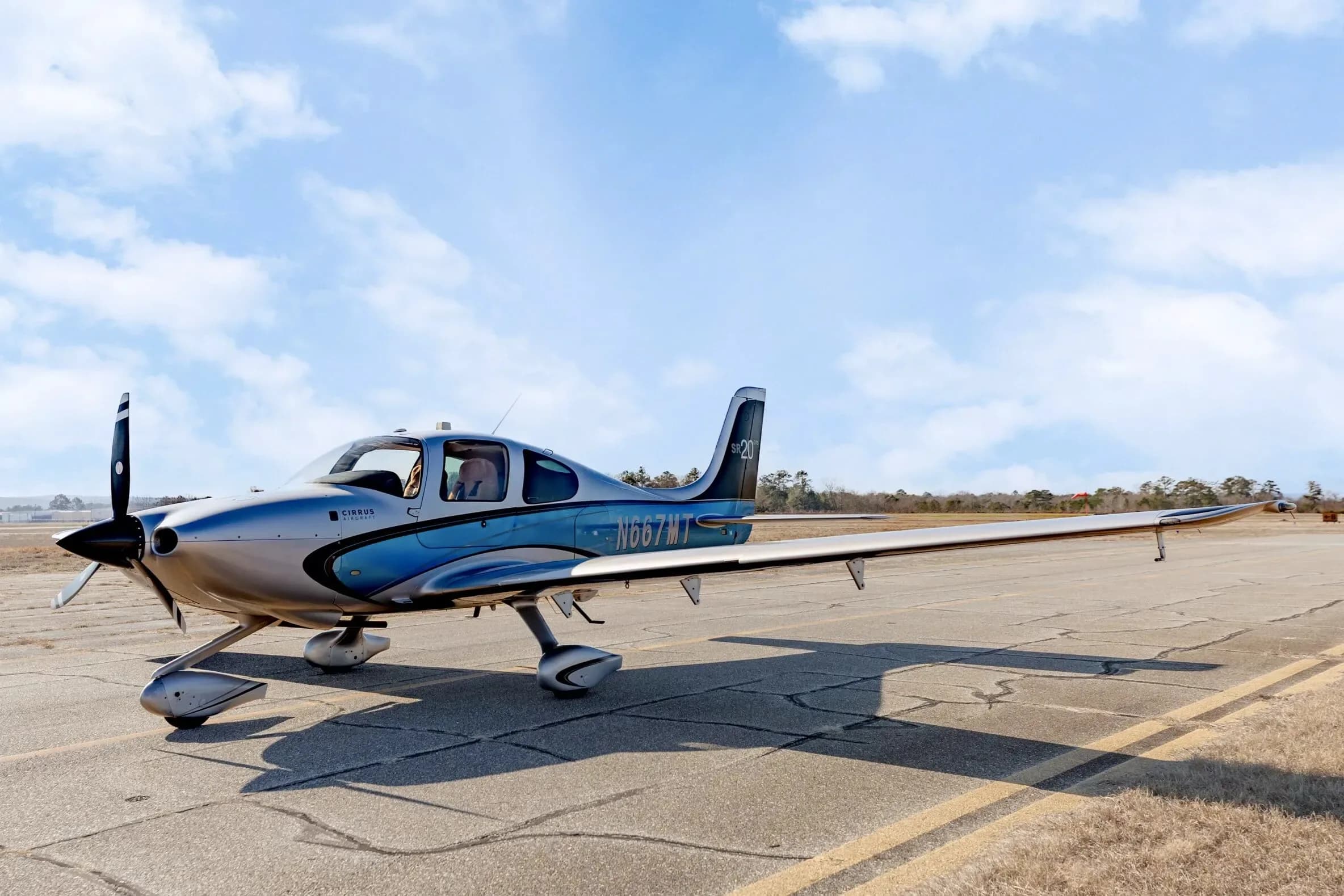 A three-quarter front view of the Cirrus SR20 GTS aircraft with N667MT registration, parked on an airfield.