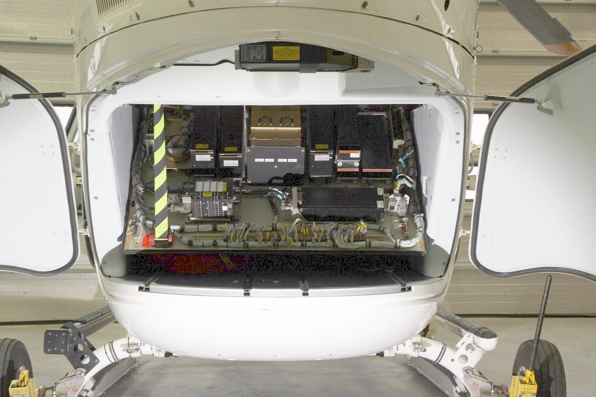 A view of the avionics bay of a helicopter with the doors open.
