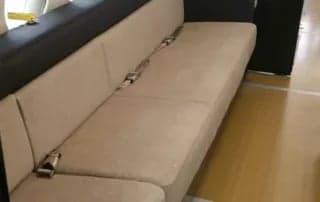 Interior view of the aircraft cabin with a beige couch.