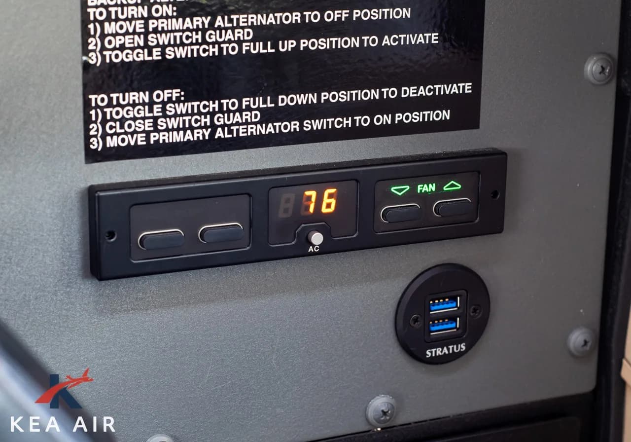 Close-up of the aircraft's electrical system controls and USB charging ports.
