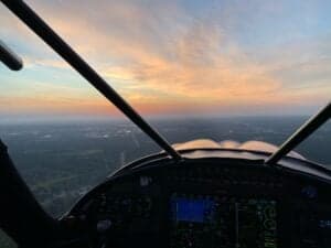 View from the cockpit of an aircraft at sunset.