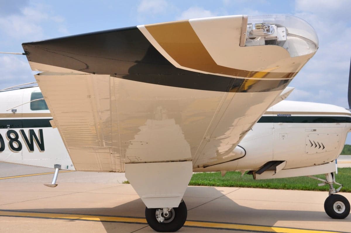 Close up of the wing and forward fuselage of a Beechcraft Bonanza aircraft.