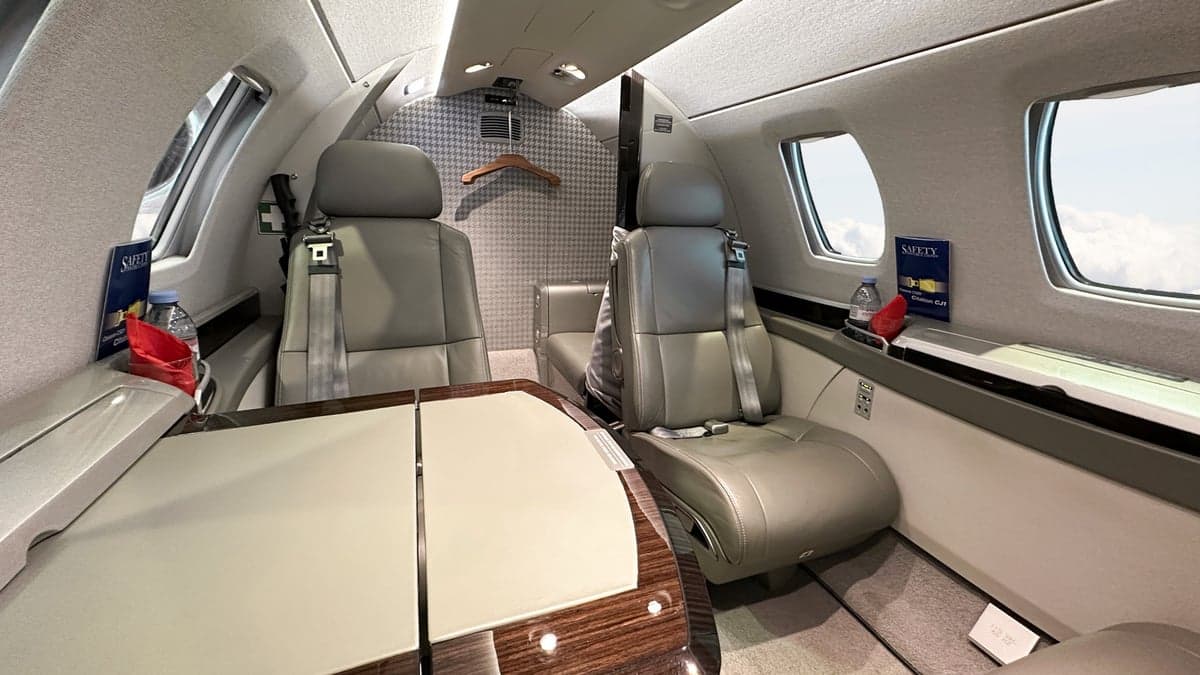 View of the cabin seats and table in a Cessna Citation CJ3.
