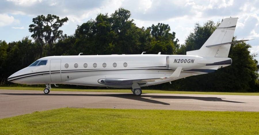 Side view of a white Gulfstream jet, registration N200GN, parked on the tarmac.