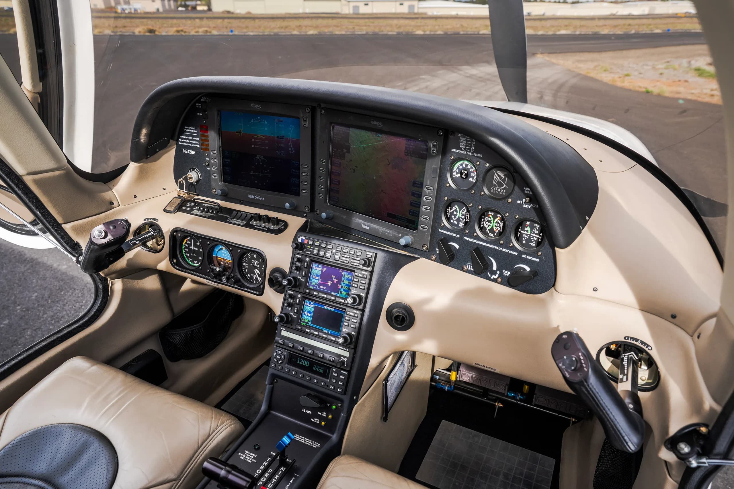 The cockpit of an aircraft, featuring a detailed instrument panel with multiple display screens and controls.