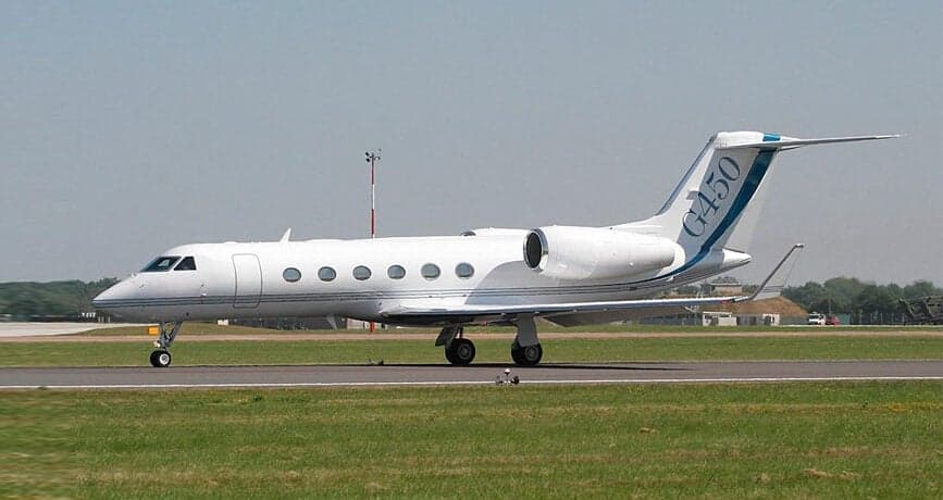 A Gulfstream G450 taxis on the runway.