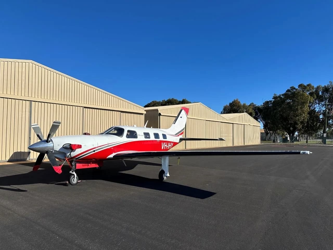 Piper PA-46 Malibu Mirage on the tarmac with a white and red paint scheme.