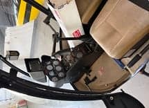 Interior view of the helicopter cabin with seats and controls.