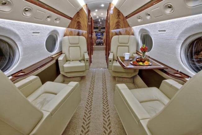 A view of the aircraft's interior, featuring comfortable seating and a table.