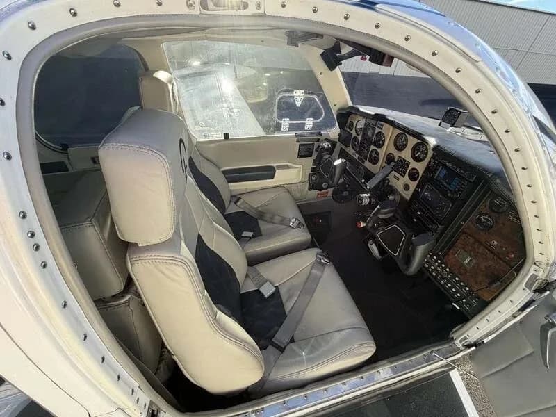 A view into the cockpit and front cabin seats of the aircraft, showing the instrument panel and controls.