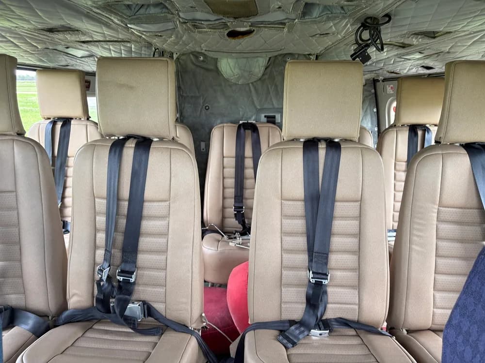 Close-up of the helicopter cabin seats with seatbelts.