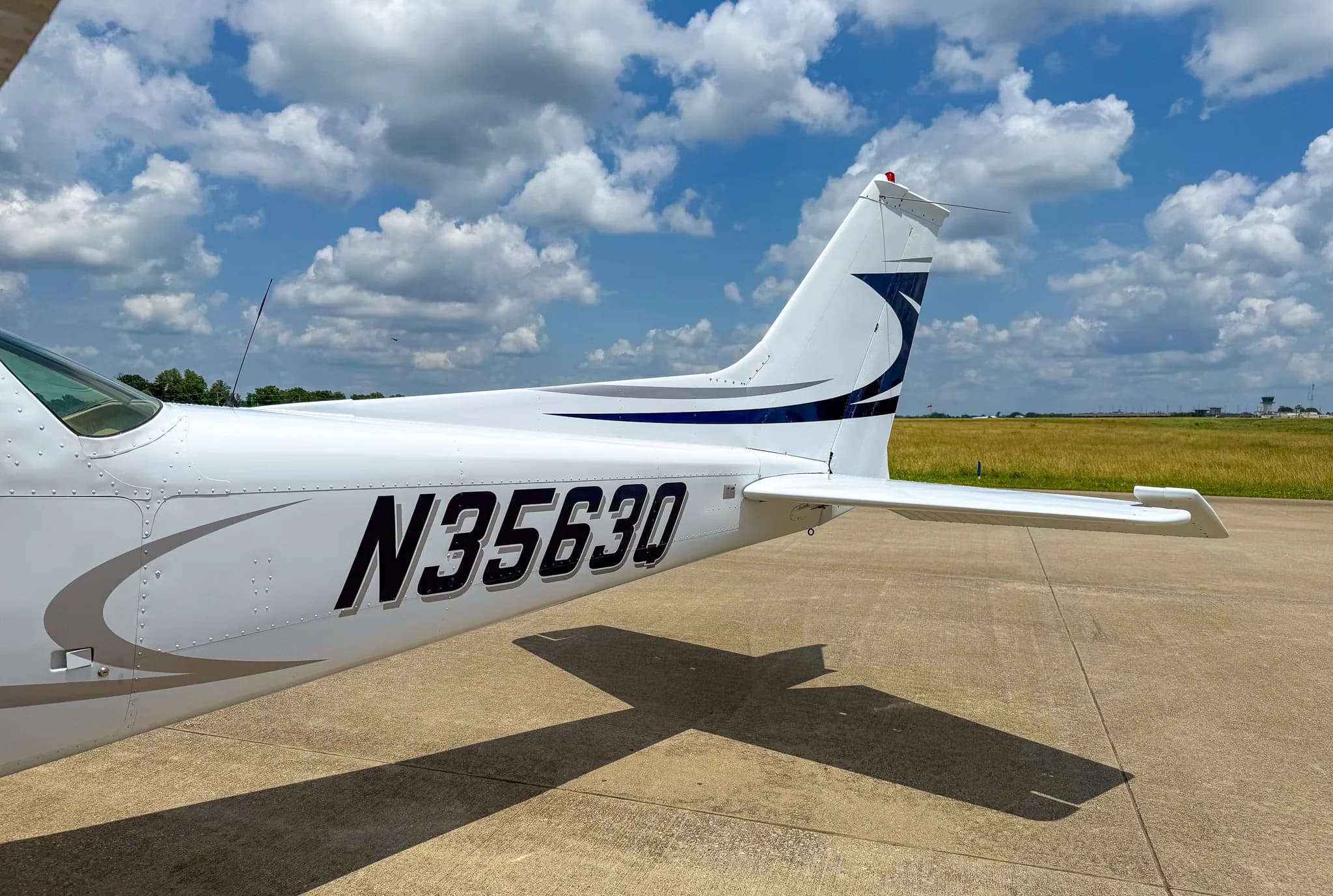 Close-up of the tail section of a white and blue Cessna 172 showing registration N3563Q.