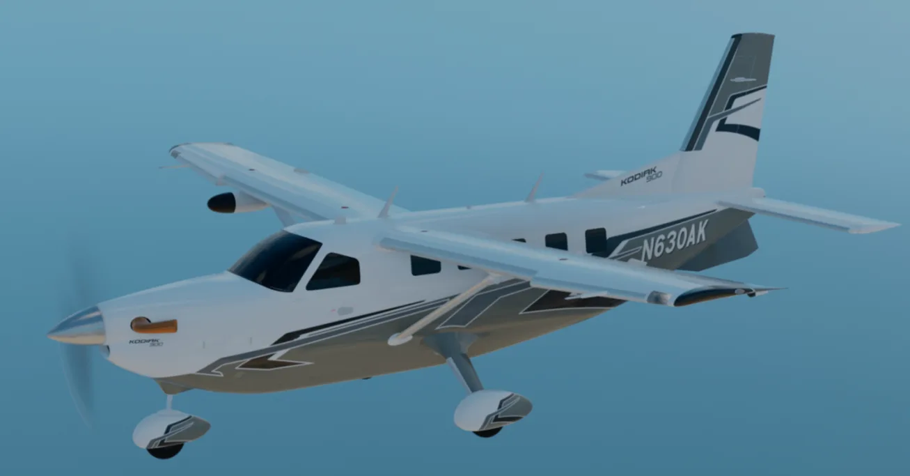 A white and grey Kodiak 100 aircraft with registration N630AK flying in a clear sky.