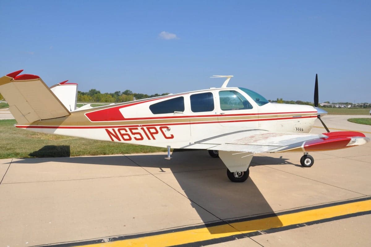A Beechcraft Bonanza aircraft with tail number N651PC is parked on the tarmac.