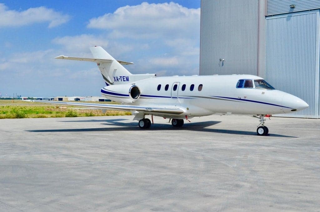 XA-TEM aircraft parked on the tarmac in front of a hangar.