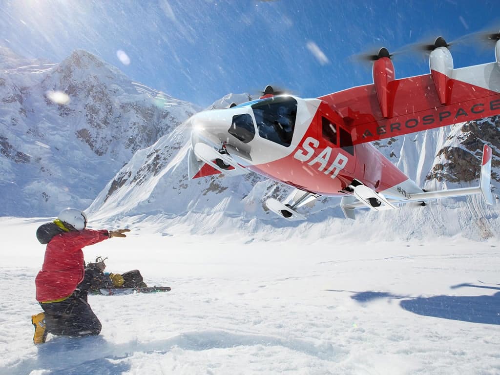 A red SAR aircraft landing near a person in a snowy mountain area.