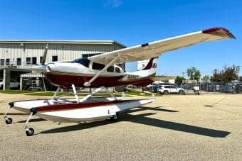 Side view of float plane N991T on the ground.