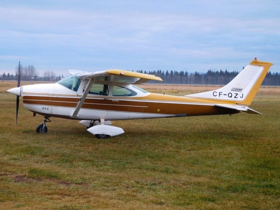 Cessna 182 Skylane parked on a grassy field.