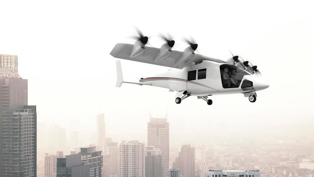 An aircraft flying over a city with skyscrapers.