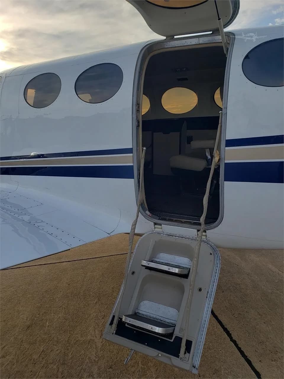 The open door and steps of a Cessna 414 Chancellor reveal a glimpse of the interior.